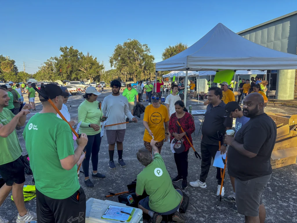 Volunteers gathering and receiving instructions at the start of a Bartow CRA community cleanup event