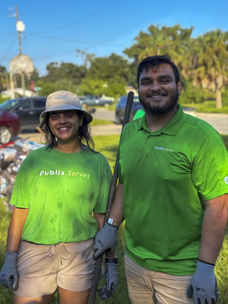 Two Publix Serves volunteers smiling after working at a Bartow CRA community cleanup event